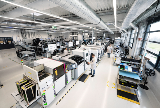 Bird's eye view of the production hall. Employees working on the machines.